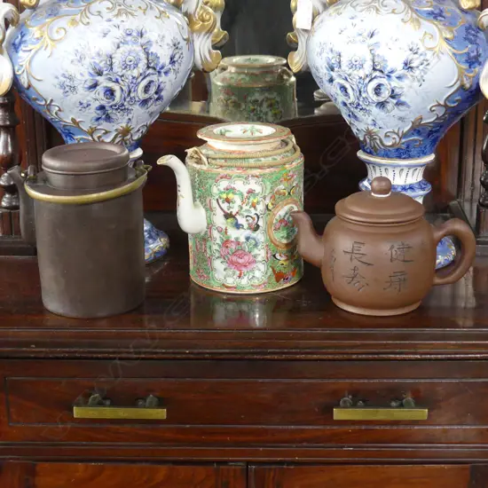  3 ORIENTAL TEA POTS; 2 YIXING WARE, 1 FAMILLE ROSE (FAULTS) H.155mm