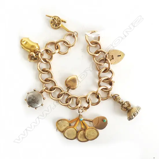 15CT GOLD CHARM BRACELET  41.2 grams including charms. Bracelet is 15ct. Clasp is 9ct. Most charms 9ct. The seal is...