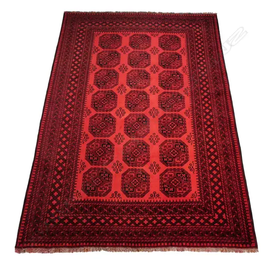 An old Ersari carpet the field decorated with numerous patterned octagonal medallions on a red ground, multiple border guards, red and black colourway. 2000 x 2850mm.