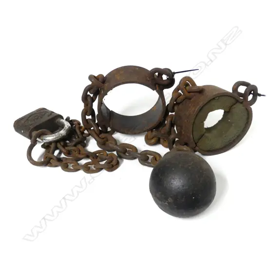 A convict's leg irons and ball with chain links with 2 modern padlocks.