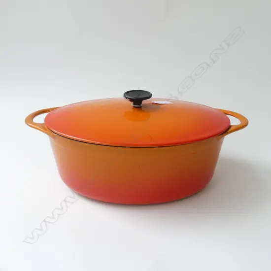 COUSANCES FRENCH ORANGE ENAMELLED CAST IRON LIDDED OVAL CASSEROLE W.360mm some wear