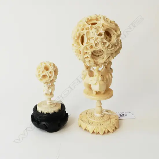 2 CARVED IVORY PUZZLE BALLS HELD HIGH BY ELEPHANTS ON CARVED IVORY STANDS H.100/150mm