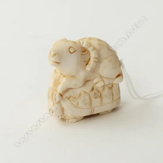 IVORY NETSUKE, GOAT SITTING ON A TORTOISE