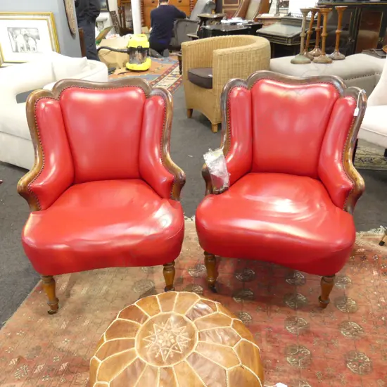 PR RED LEATHER ARMCHAIRS, (one castor detached but present) 660 x 600 x 880mm