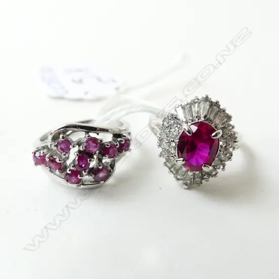2 SILVER DRESS RINGS: 1 W RUBIES other red & white stones 1 missing SIZE L & O
