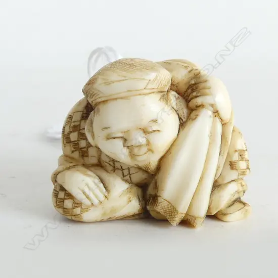 JAPANESE CARVED IVORY NETSUKE of the GOD DAIKOKU with SACK