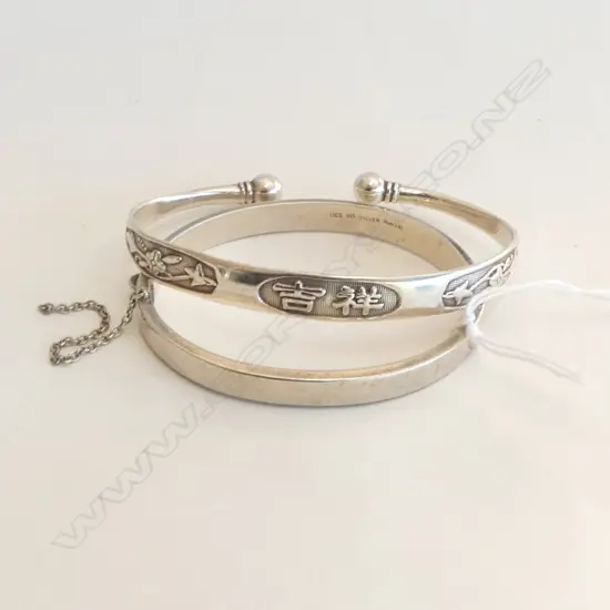 2 SILVER BANGLES: 1 HINGED the other Chinese with symbols of cuff form