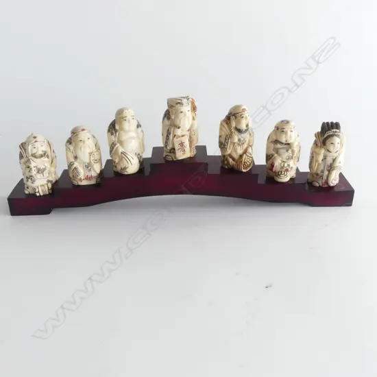 COLLECTION OF 7 BONE NETSUKE ON STAND L260MM