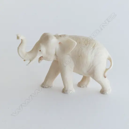 IVORY CARVED ELEPHANT trunk raised. L.85mm.
