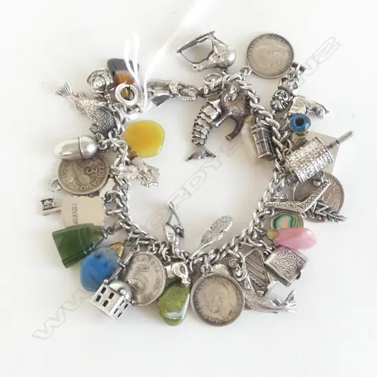 VINTAGE SILVER CHARM BRACELET loaded with charms mostly silver + paua + gem stones etc 70gms