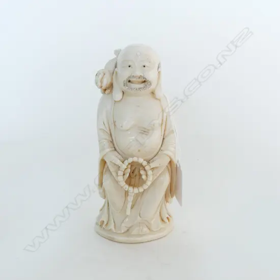 ORIENTAL CARVED IVORY LARGE FIGURE OF A DEITY with shishi to his shoulder H.150mm. 420gms.
