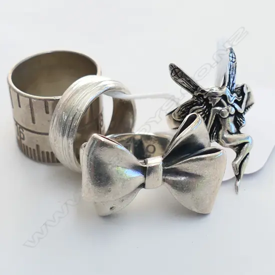 4 SILVER RINGS; STOLEN GIRLFRIENDS BOW, TAPE MEASURE, ANGEL, BAND 37.5 GM