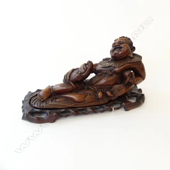 ORIENTAL CARVED WOODEN RECLINING FIGURE ON STAND W.390mm