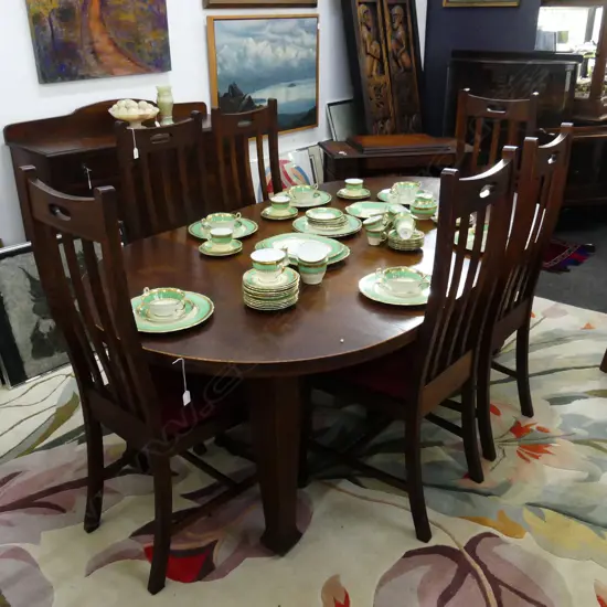 AN OAK DINING TABLE WITH THREE LEAVES AND SIX CHAIRS EX 1912 AUCKLAND EXHIBITION L EXTENDED 2000 MM
