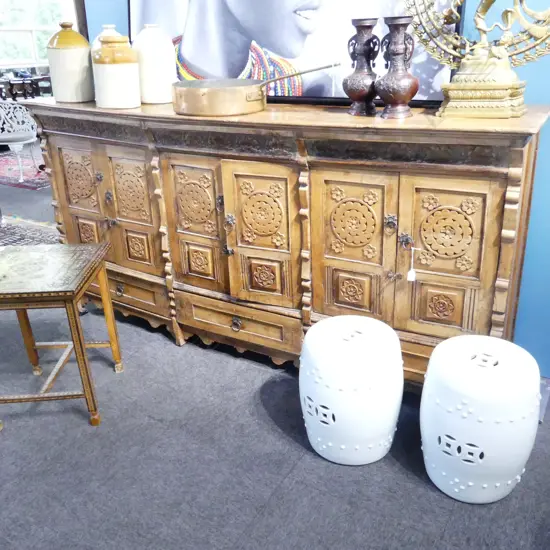 LARGE INDONESIAN HEAVILY CARVED HARDWOOD SIDEBOARD WITH THREE CUPBOARDS AND THREE DRAWERS BELOW. 2150x490x1080mm