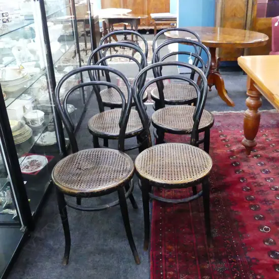 SET 6 EBONISED CANE SEATED BENTWOOD CHAIRS ONE SEAT DAMAGED. 