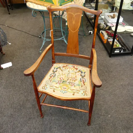 MAHOGANY SHERATON REVIVAL CARVER CHAIR. WITH STRINGING SERPENTINE SHAPED TOP OUTSWEPT ARMS AND TAPESTRY SEAT 