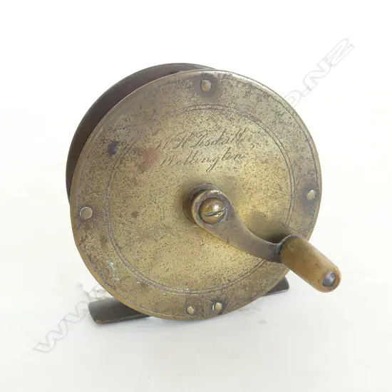 A Pye: 2 3/4"x 1 1/4"brass REEL with serpentine arm & horn handle engraved W.H. Tisdalls Wellington. c1895