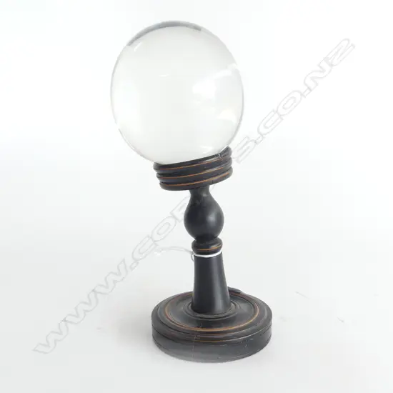 GLASS BALL ON EBONISED TURNED WOOD STAND H.180mm.