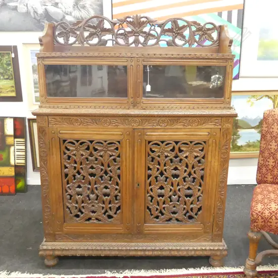 ORNATELY CARVED CUPBOARD WITH GLAZED UPPER SECTION IN TWO PIECES H 1590 W 1200
