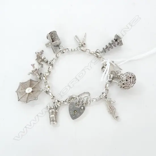SILVER CHARM BRACELET, 10 SILVER CHARMS, 26.2gm