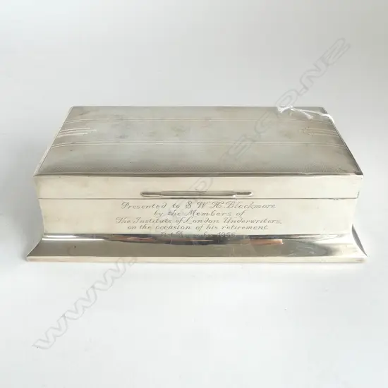 A mid 20thC silver presentation large cigarette box with fine machine engraving. Sheffield 1955. Walker & Hall. 749gms. Cedar lined. L.200mm.