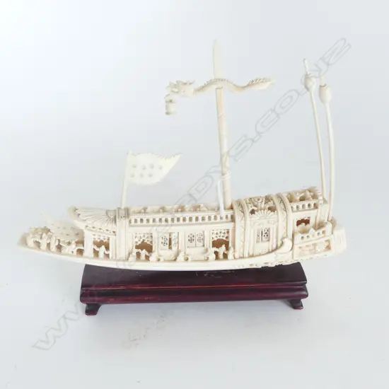 CHINESE FINELY CARVED IVORY ELABORATE JUNK on wood stand with flag & asst poles. L.205mm.