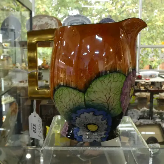 CARLTONWARE ART. DECO MODERNE JUG ORANGE L,USTRE IN HOLLYHOCKS PATTER, WITH WAVY SHAPED GILDED HANDLE H.140mm