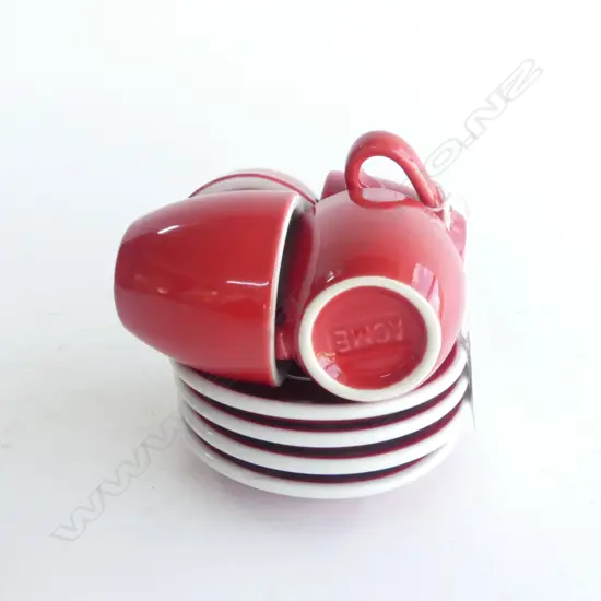 FOUR ACME RED GLAZE CUPS & SAUCERS