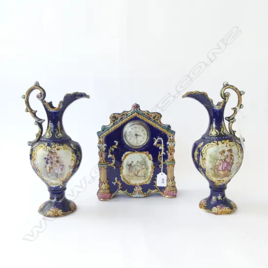 EDWARDIAN CHINA CLOCK H240MM & PR OF MATCHING JUG SIDE ORNS ONE REPAIRED