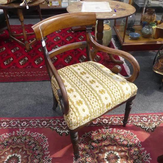 WILLIAM IV MAHOGANY SCROLL ARM CHAIR with tulip carved legs