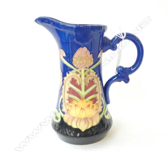 Old Tupton ware like tube lined blue jug with Sevres style factory mark. H.185mm 