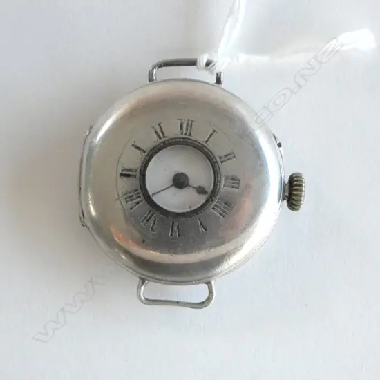A c.1908 gent's silver half hunter wristwatch, the white enamel dial with black Roman numerals, (hair crack)