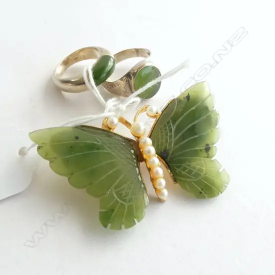 TWO SILVER AND POUNAMU RINGS AND A POUNAMU AND PEARL BROOCHS