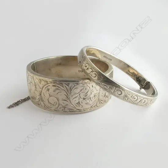 2 SILVER ENGRAVED BANGLES the widest slightly dented. The other narrow bangle with faulty clasp 57.8gms