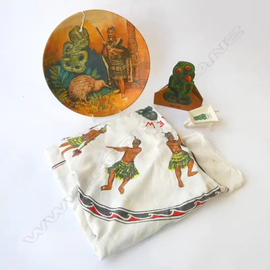 THREE VINTAGE MAORI THEMED PIECES; PRINTED TABLE CLOTH, 'TOURIST ART' WHEELBARROW, PRINTED PLATE + PAINTED TIKI