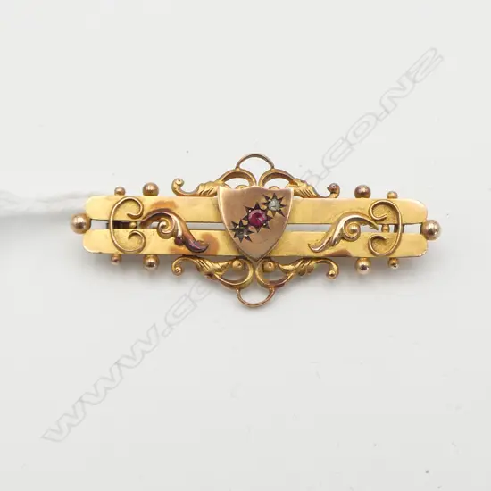 VICTORIAN 9CT AND RUBY BAR BROOCH one diamond missing