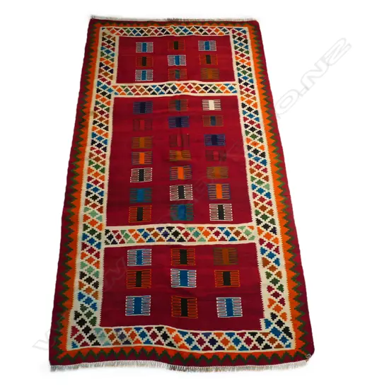 A Persian hand-woven kilim rug,