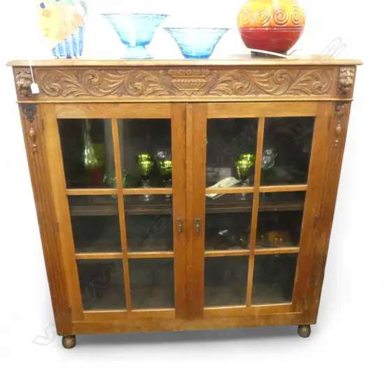 C1900 EUROPEAN OAK DISPLAY CABINET panelled dble doors. Lion mask + bird + flowering urn detail.