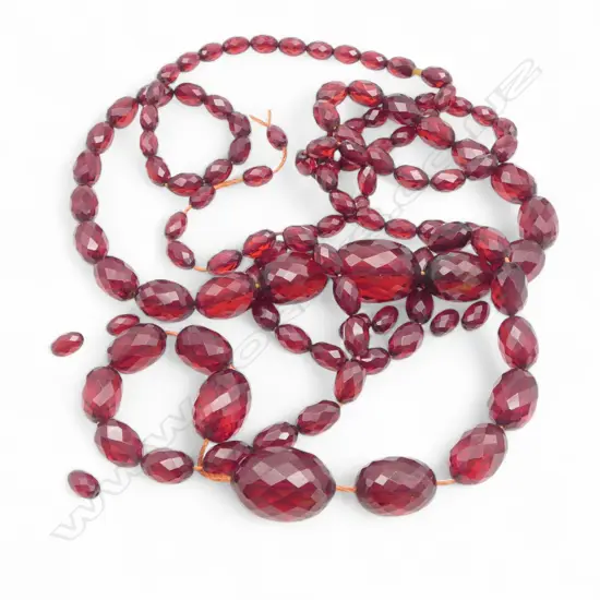 Very long strand of vintage facetted synthetic red amber bead necklace. Dble graduated L.1600mm. Broken but connected