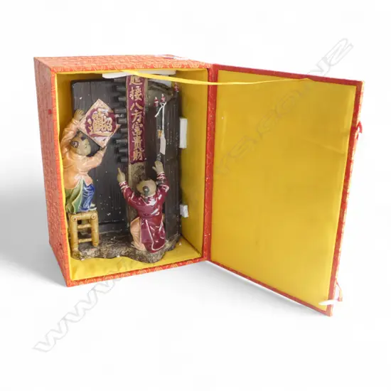 A CHINESE SHIWAN FIGURAL GROUP DEPICTING CHILDREN HANGING A FESTIVE DECORATION 350MM (h) with presentation box