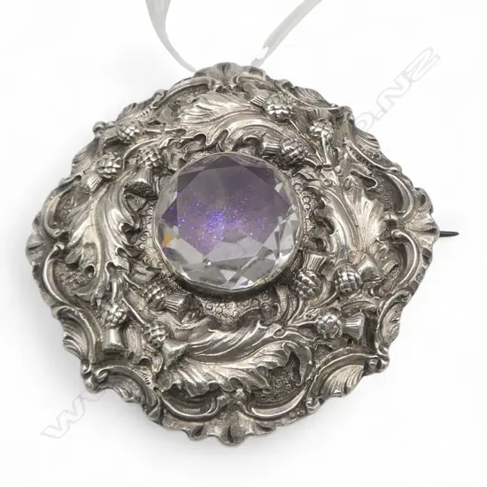 Impressive Scottish relief thistle decorated brooch set with large central stone. Dia.52mm