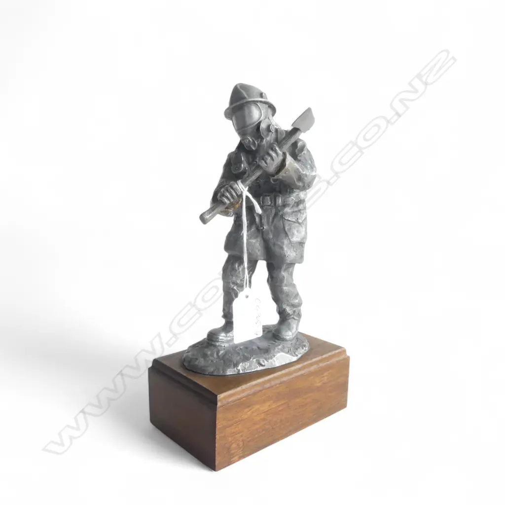 CAST HEAVY WHITE METAL SCULPTURE OF A FIRE FIGHTER. With breathing apparatus and axe. On wood base. H.260mm. Image 1++