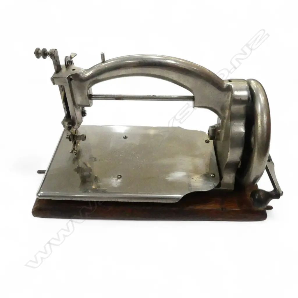 EARLY 20thC SMALL 'IDEAL SEWING MACHINE' chromed on oak base w black tin cover. Hand operated. L.255mm Image 1++