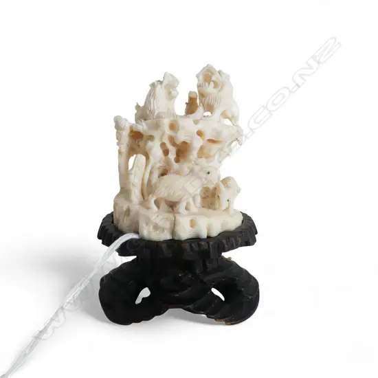ORIENTAL BONE ORNAMENT ON WOODEN STAND caved and pierced animal design H.80mm