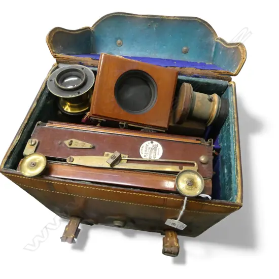A c.1900 Thornton Pickard 'Amber' quarter plate folding mahogany camera with extras in leather case