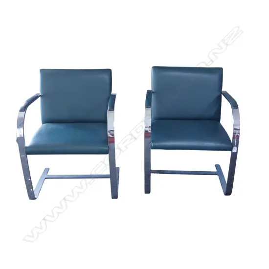 A pair of green leather and stainless steel cantilever chairs