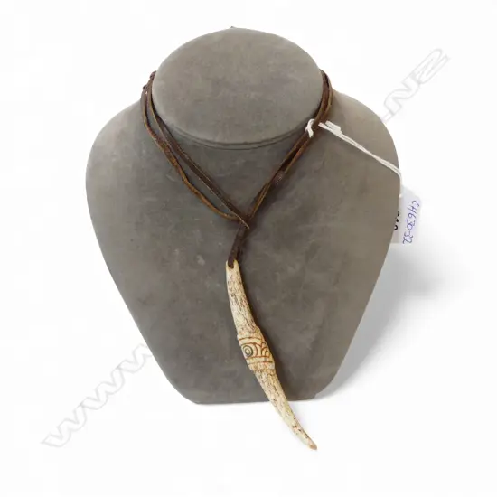 David Tuart carved whalebone Maori aurei pendant. The stylised head with paua ring insert. L.106mm.....