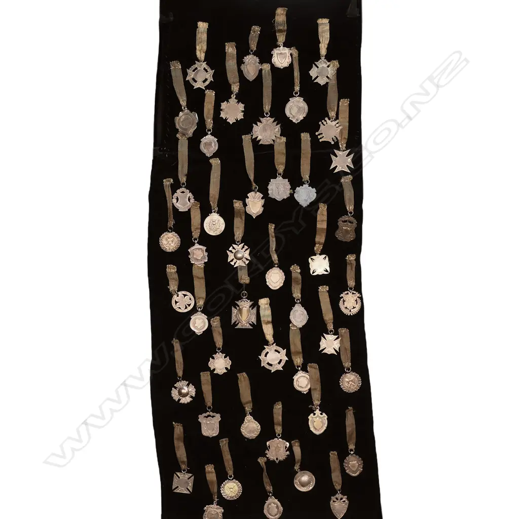 c.1940s AUCKLAND JEWELLER'S 44 SILVER FOB MEDALS ON BLACK VELVET, 270 x 1020mm, some hallmarked, Est weight. 308gm Image 1++