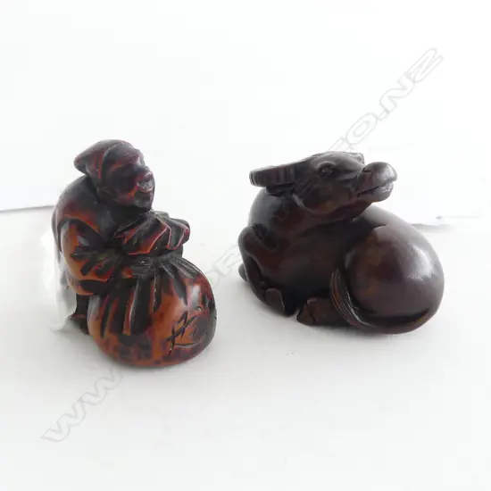 TWO CARVED WOOD NETSUKE; OLD MAN & BAG & WATER BUFFALO